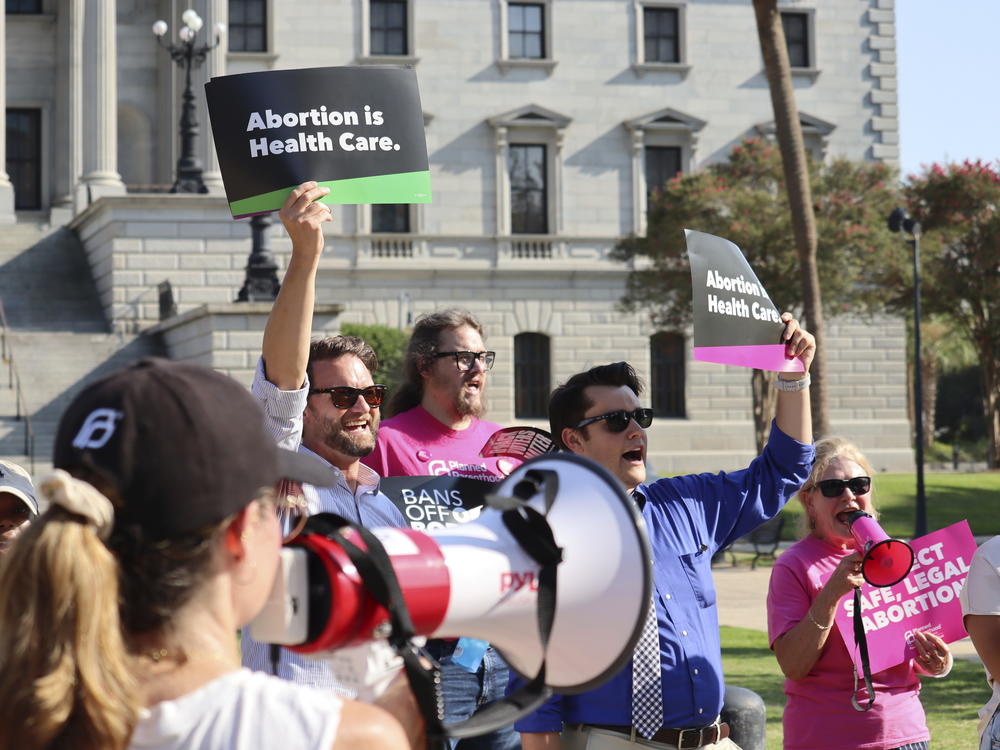 Over two dozen abortion-rights supporters attend a rally outside the South Carolina State House in Columbia, S.C., on Aug. 23, 2023. The South Carolina Supreme Court ruled to uphold a law banning most abortions except those in the earliest weeks of pregnancy.