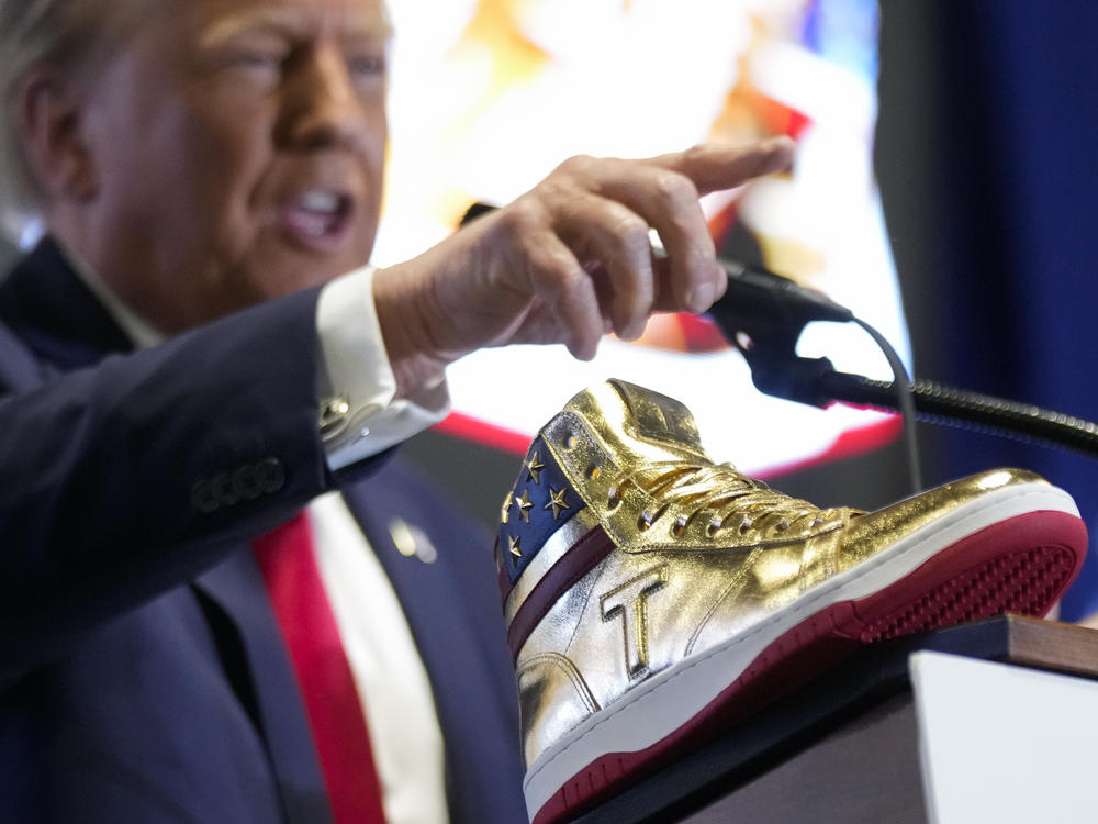 Republican presidential candidate Donald Trump unveils his golden high-tops on Saturday at Sneaker Con Philadelphia, an event popular among sneaker collectors.