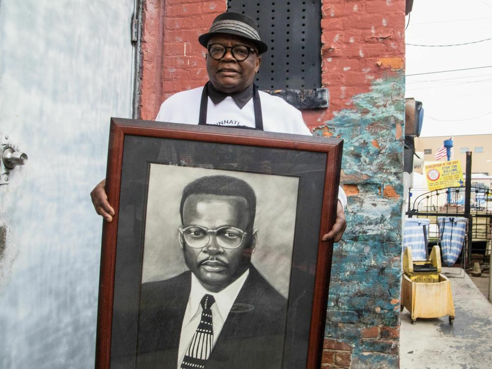 Ollie's Trolley owner Marvin Smith holds a picture of himself that Williams Rankins Jr. did in the 1990s.