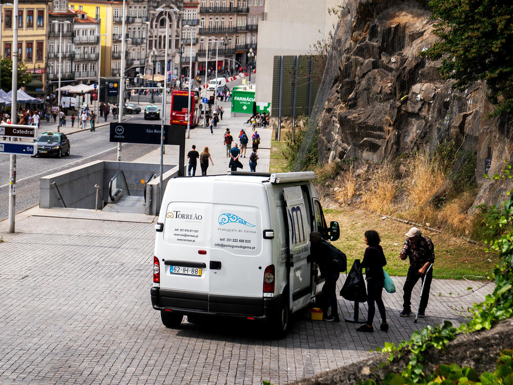 Drug consumers line up outside of the SAOM van for a methadone cocktail and supplies in the city center of Porto, Portugal last spring.  There are very few overdose deaths in the country where drug addiction is treated as an illness rather than a crime.<a href=