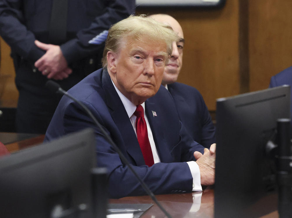 Former President Donald Trump attends a pretrial hearing Thursday for charges he faces in a New York hush money case. Two civil judgments in New York have put Trump on the hook for hundreds of millions of dollars.