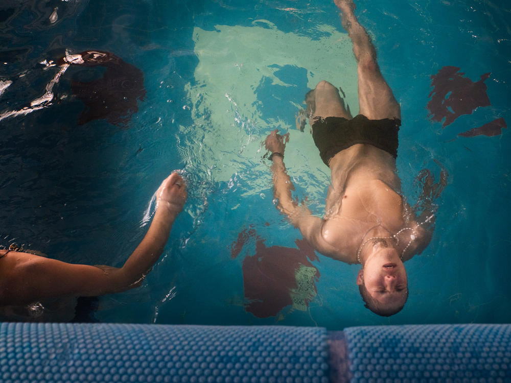 Soldiers spend time swimming in the pool during a one-week course of rehab at a center in northeastern Ukraine.