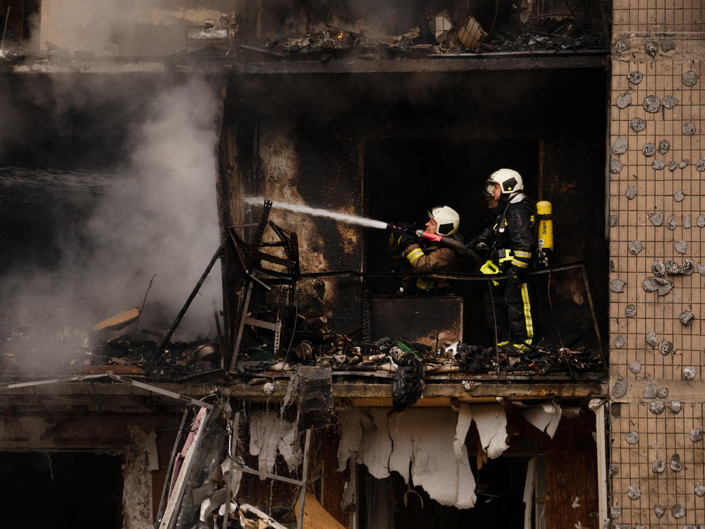 Firefighters work to contain a fire in one of Kyiv's residential buildings that was hit by a Russian missile strike on Jan. 2.