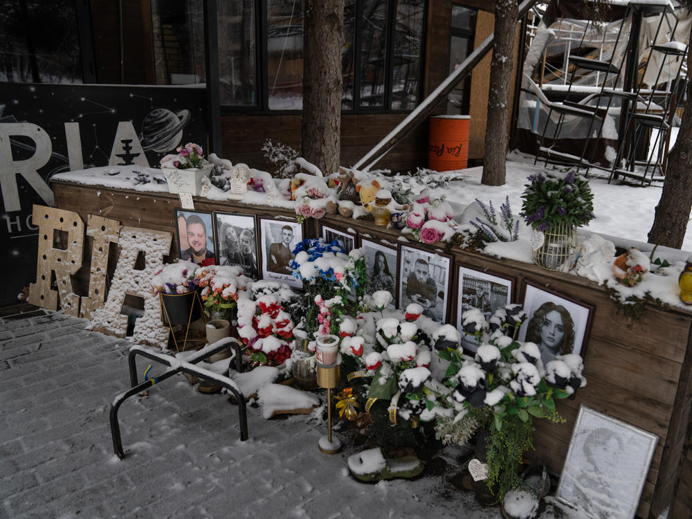 A memorial is set up among the remains of Ria Pizzeria, a beloved restaurant in Kramatorsk that was hit by a Russian strike in June 2023, killing staff and customers.