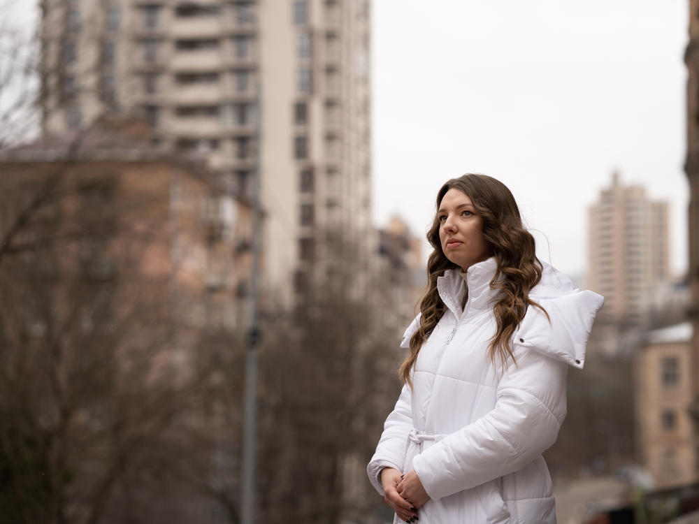 Lytvynova stands near an apartment building in her Kyiv neighborhood that was damaged by multiple Russian strikes over the course of the war.