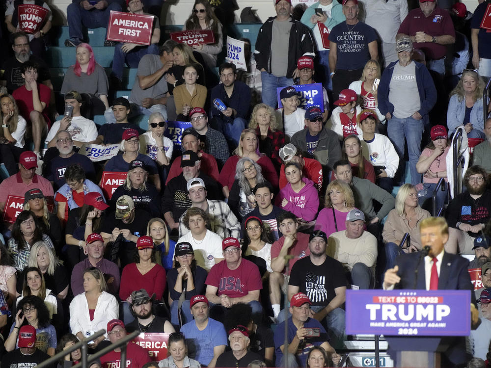 Supporters look on as Republican presidential candidate former President Donald Trump speaks to supporters during a rally Feb. 10 in Conway, S.C. As Trump has tried to remake the GOP in his image, local parties have resorted to infighting.