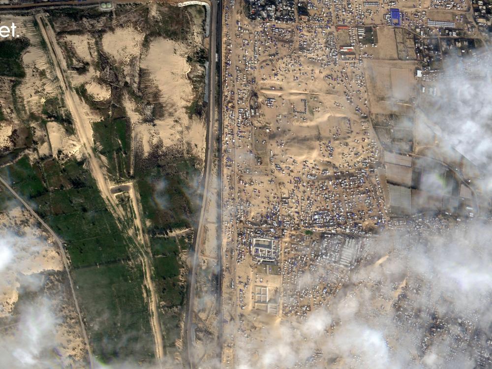 This Feb. 18 satellite photo shows displaced Palestinians crammed into southern Gaza on the right. Israel is threatening to attack the border town of Rafah, where more than 1 million Palestinians are now living. On the left is the vast, empty expanse of Egypt's Sinai Peninsula. Egypt says it won't allow Palestinians into Egypt because it fears they might not be allowed back into Gaza.