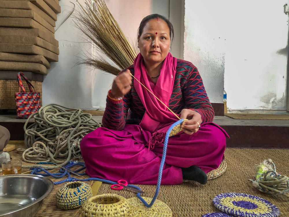 Sunita Kumari Chaudhary weaves a dinner table mat with ropes once used by climbers in the Himalayas. She and her fellow craftswomen are part of a small start-up project in Kathmandu Valley, Nepal, to repurpose Everest trash.