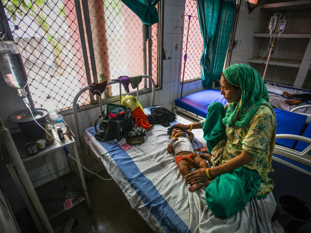 A 7-month-old child with diarrhea lies in a bed at a hospital in India. Oral rehydration salts are a cheap and effective treatment but are underused. A new study aims to find out why.