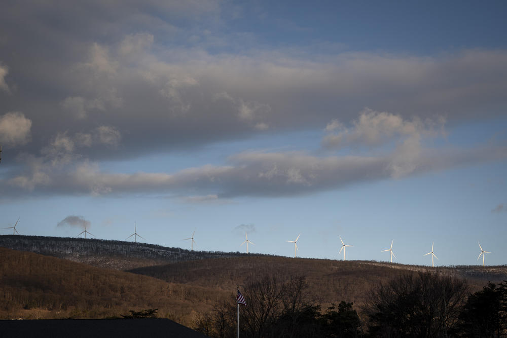 Wind turbines form a backdrop to Keyser.