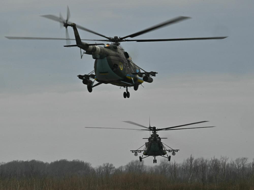 Ukrainian military MI-8 helicopters fly at a low altitude in the Kharkiv region on April 2, 2023, amid the Russian invasion of Ukraine. Maksim Kuzminov, a Russian army defector who is suspected of being the person found dead in Spain, flew such military helicopters.