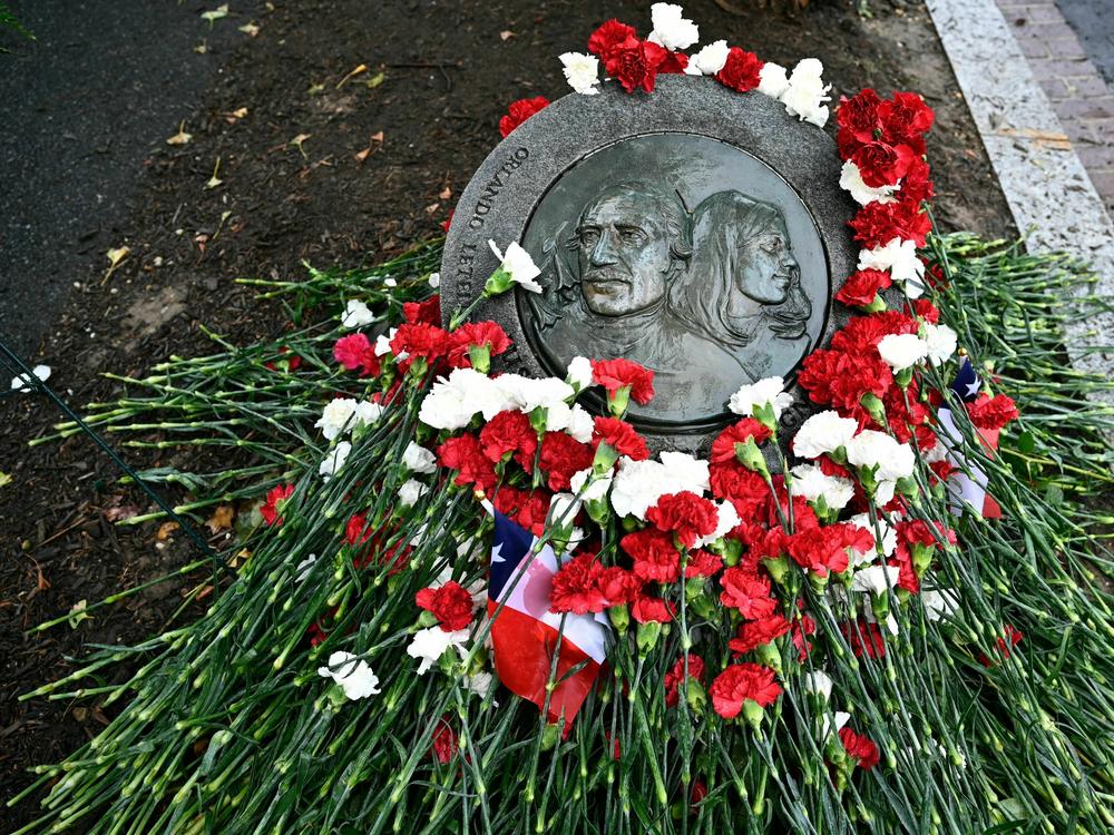 Flowers adorn the memorial plaque at the site where Orlando Letelier and Ronni Moffitt where killed in Washington, D.C. They were killed in a car bomb on Sept. 21, 1976, by agents of Chilean dictator Augusto Pinochet as they drove to work at the Institute for Policy Studies.