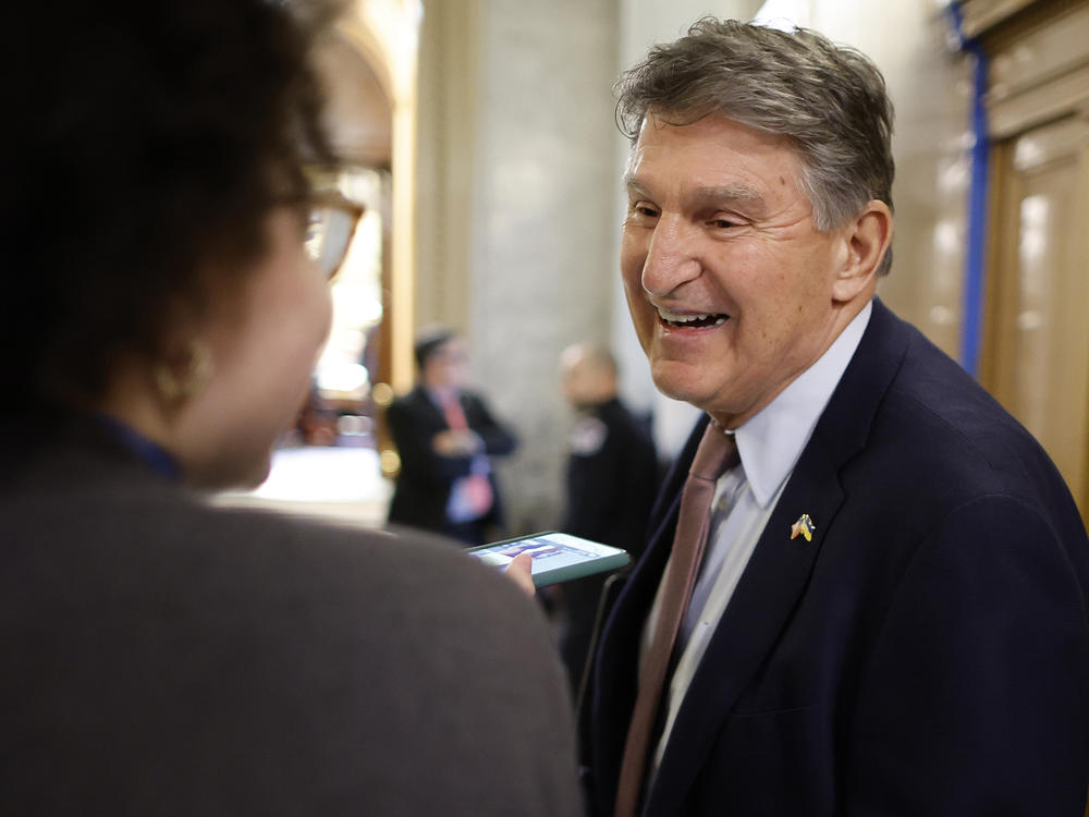 Sen. Joe Manchin, D-W.Va., talks to reporters between votes at the U.S. Capitol.