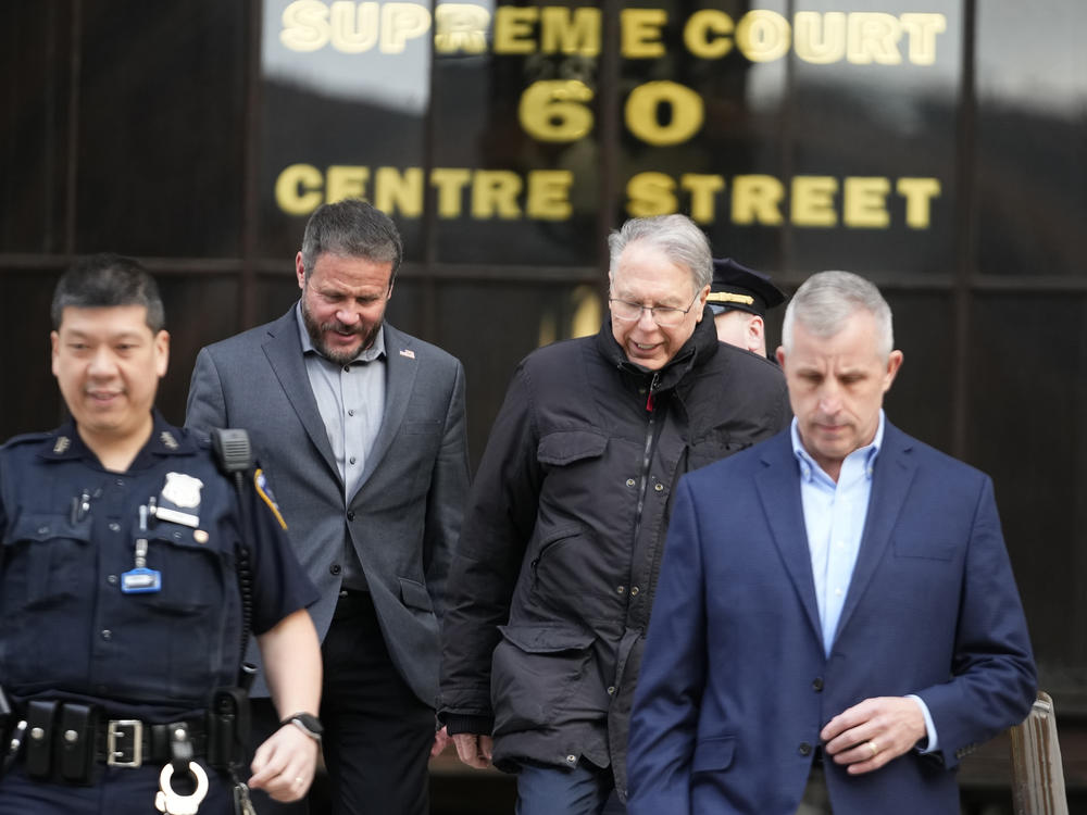 Former NRA CEO Wayne LaPierre (second from right) leaves New York State Supreme Court on Wednesday. Top NRA executives for were accused of using millions in donations for private luxuries.