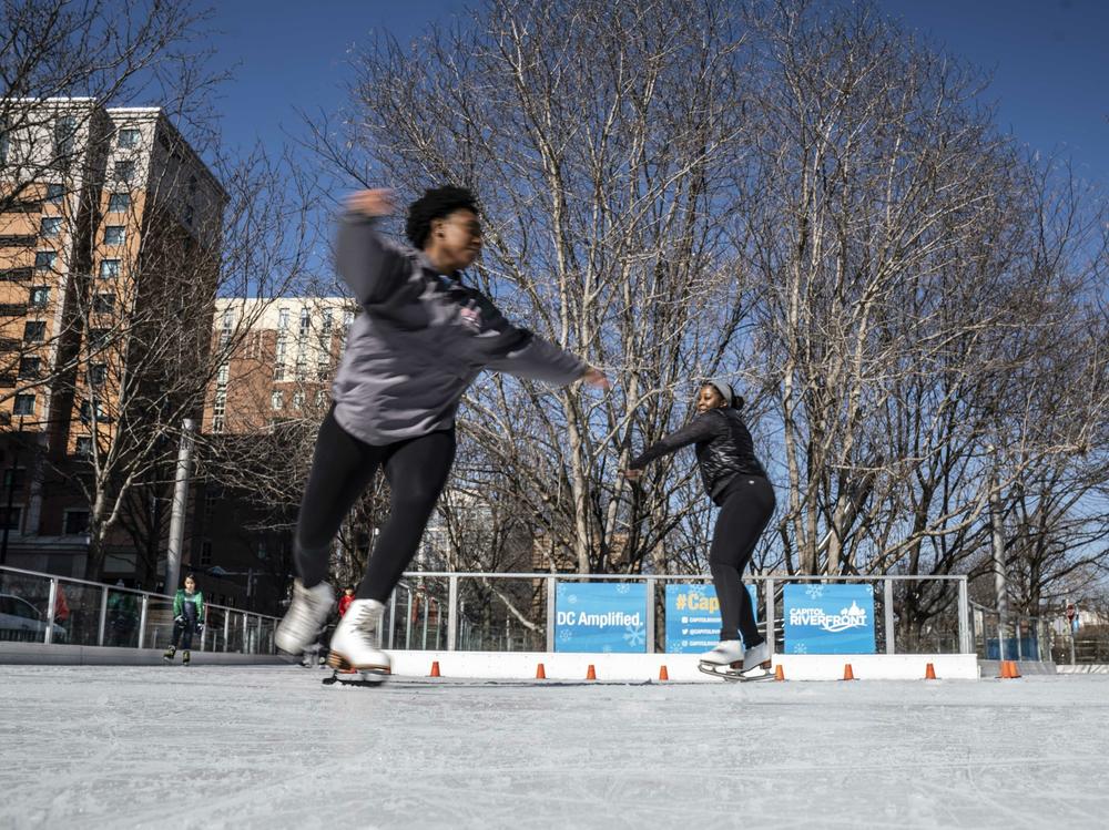Cheyenne Walker and Maya James of Howard University's figure skating team practice their skills at Canal Park Ice Rink in Washington, D.C.