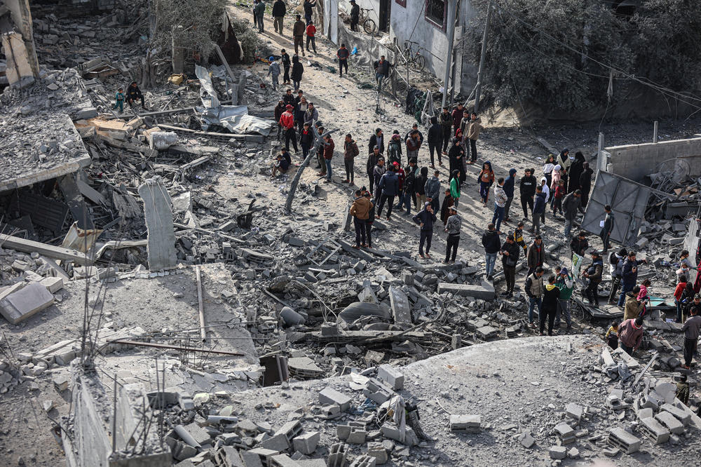 Palestinians inspect their destroyed homes after an Israeli air strike killed more than 60 people in Rafah, southern Gaza Strip, Feb. 12.