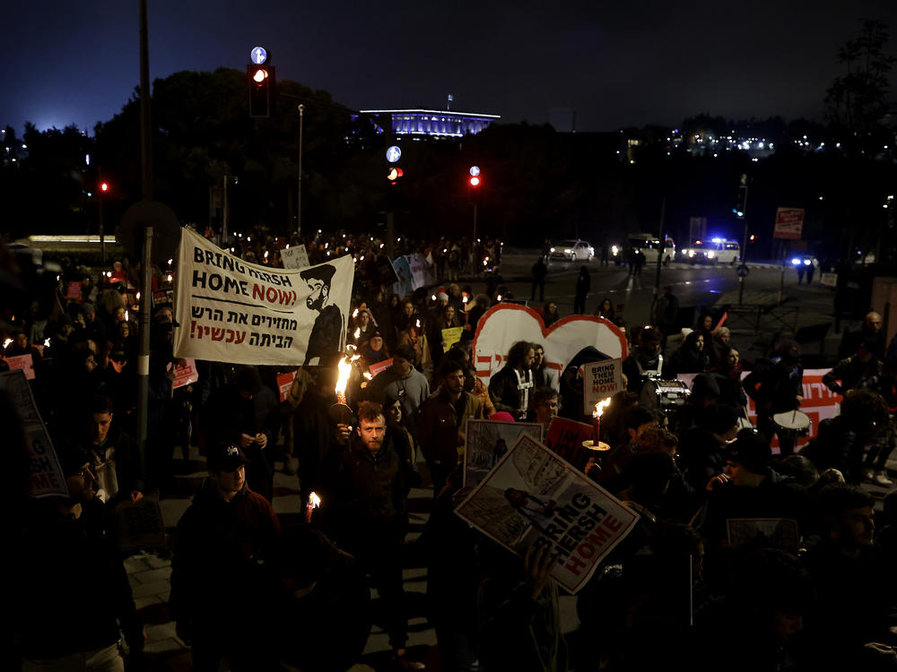 Protesters in front of the Knesset, Israel's parliament, hold torches during a march demanding the release of hostages held by Hamas in the Gaza Strip on Feb. 19 in Jerusalem.