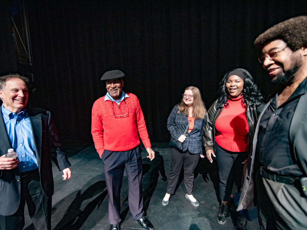 Donald Cole, red sweater, and Kenneth Mayfield, right, talk with University of Mississippi students, Emerson Morris and Aminata Ba, right, at Fulton Chapel, the site of a protest for racial equality during a concert in 1970. Former 