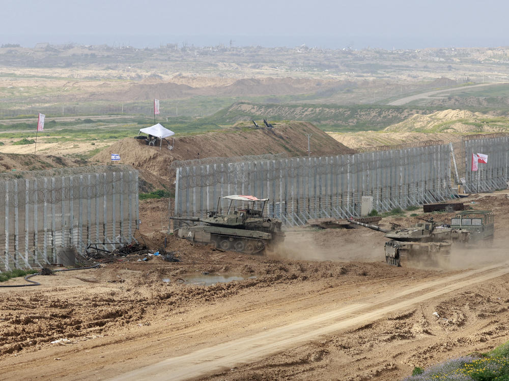 This picture, taken from a position in southern Israel near the border with the Gaza Strip, shows Israeli battle tanks crossing the border into northern Gaza on Monday, Feb. 19.