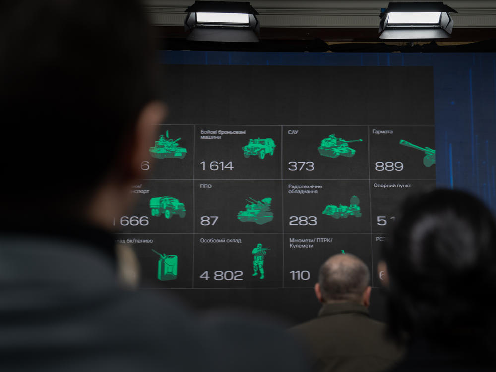 Attendees of the Ukraine 2024 forum look at a presentation about use of drones during the war with Russia.