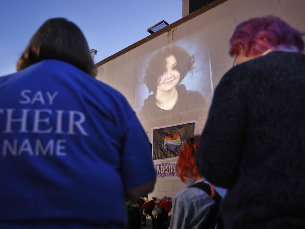 A photograph of Nex Benedict, a nonbinary teenager who died one day after a fight in a high school bathroom, is projected during a candlelight service at Point A Gallery, Saturday, Feb. 24, 2024, in Oklahoma City.