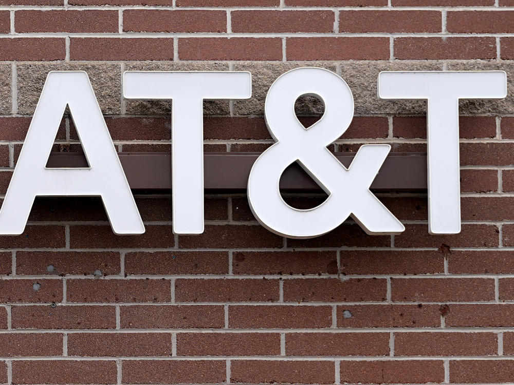 The company logo hangs over the door to an AT&T store Thursday, Feb. 22, 2024, in Denver.