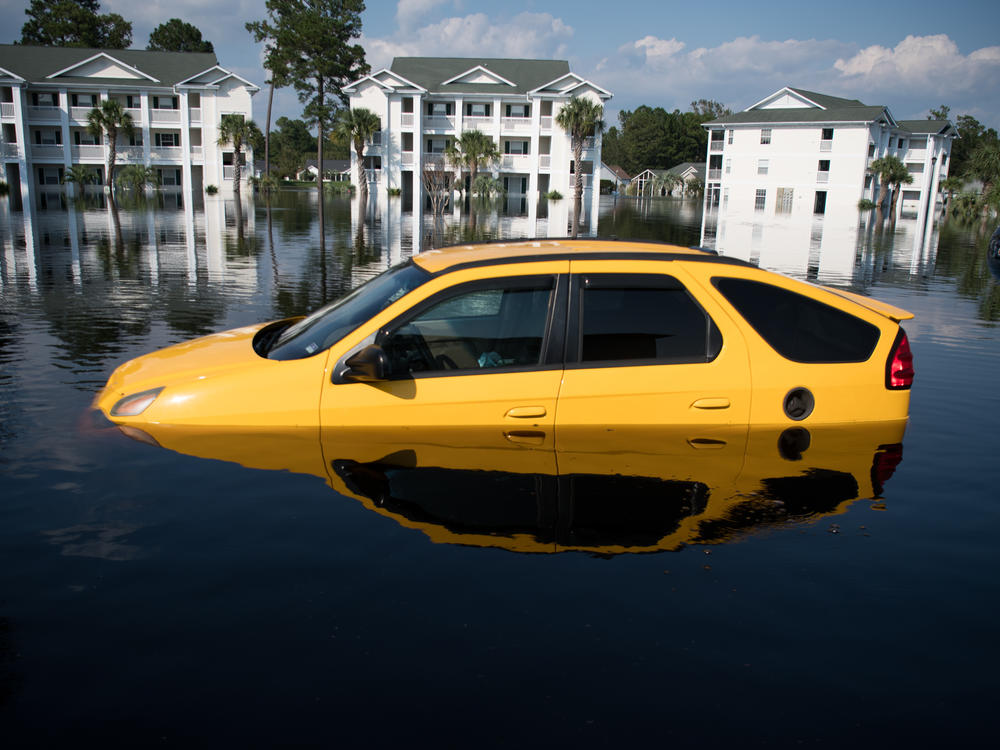 Climate change makes intense floods, wildfires, hurricanes and heat waves more common. Recovering from a disaster can be expensive. Here, a flooded car after Hurricane Florence hit South Carolina in 2018.