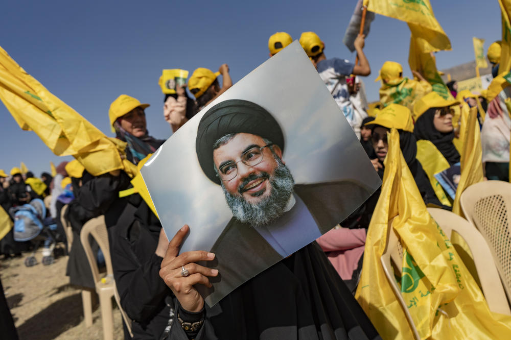 A woman holds a photo of Hassan Nasrallah at a party rally in 2022 in Baalbek in Bekaa Valley, Lebanon.
