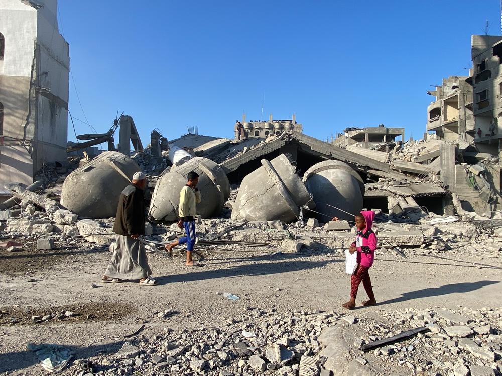 People survey the remains of a mosque Sunday, Feb. 25, that had been leveled by Israeli strikes on Rafah.