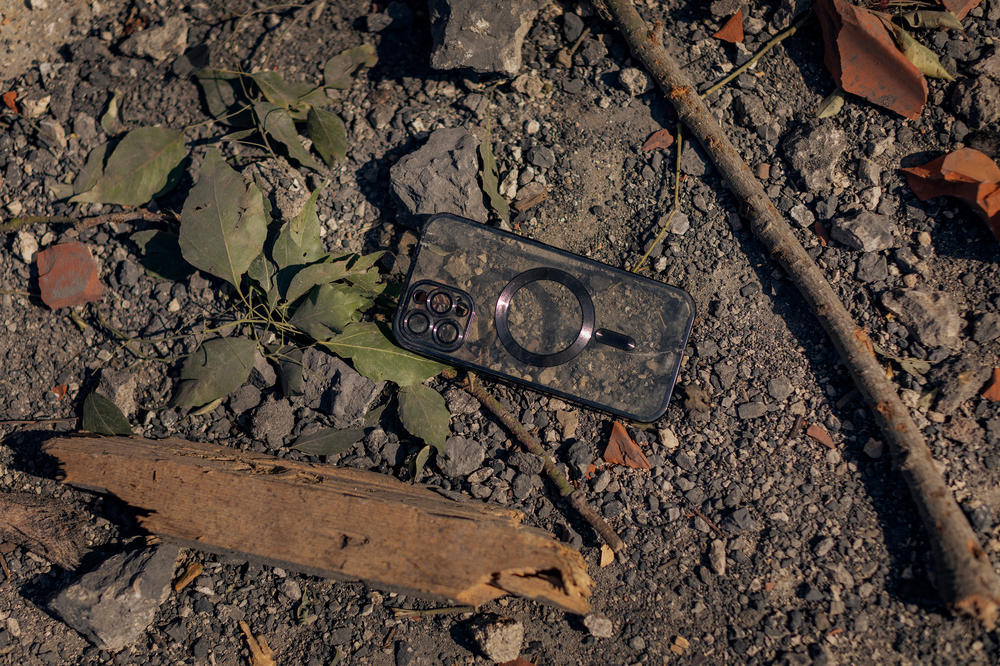 An empty cellphone case lies on the ground near where an Israeli airstrike hit in Majdal Zoun.