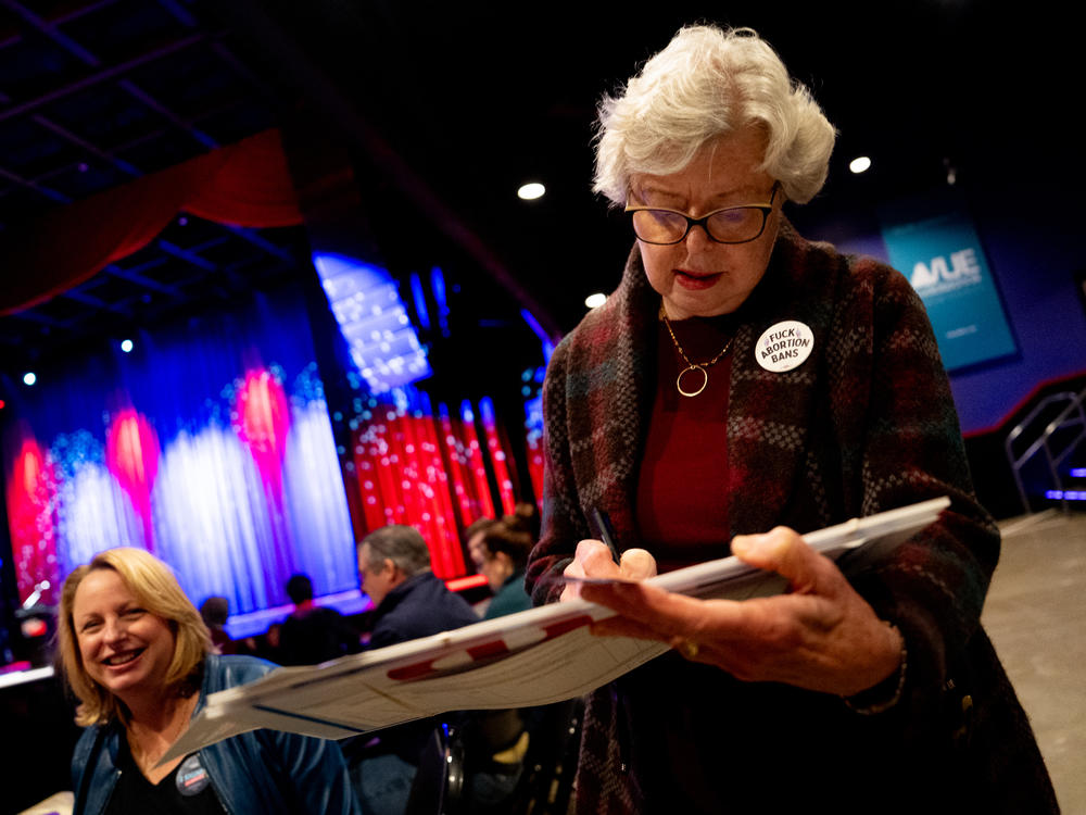 Enola Proctor, 75, of Olivette, Mo., signs a petition for a Missouri constitutional amendment that would legalize abortion up until fetal viability.
