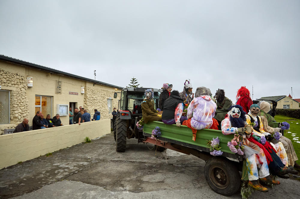 The Okalolies' tractor arrives at the Prince Phillip Hall, home to the village's town hall and the only pub on the island, to deliver King Charles and his queen. After they've roamed around the community for a few hours, the Okalolies pick up a tractor and trailer to collect the wife of the U.K.'s representative on the island, as well as the wife of the Chief Islander.