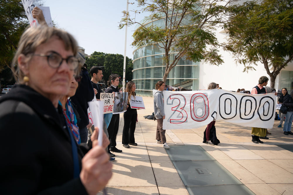 Israeli demonstrators hold an anti-war protest on Feb. 27 in Tel Aviv, Israel, with signs that say 30,000 to signify the Palestinian death toll in Gaza since Oct. 7.