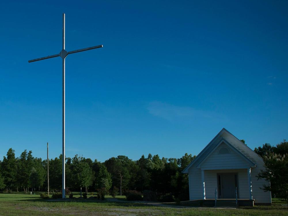 A giant cross next to a small church in Vance, Alabama. The state is among those where views supporting Christian nationalism are the strongest in the country, according to a new survey.