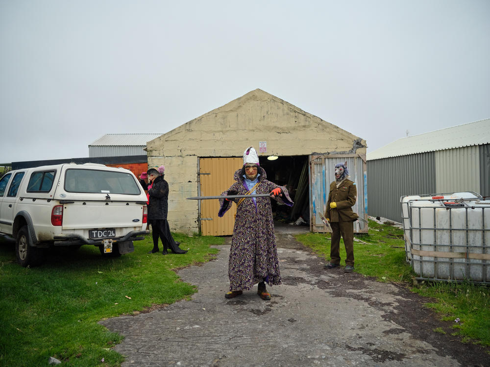 An Okalolie dressed as King Charles III walks out of their clandestine changing room. In honor of the king's coronation last year — Tristan da Cunha is a British overseas territory — two participants transformed themselves into the king and queen.