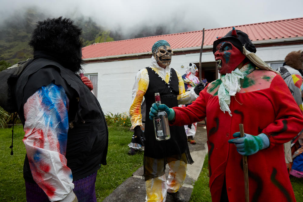 A group of Okalolies share a drink while on a break from roaming around the village. The Okalolies are often invited for a drink by 