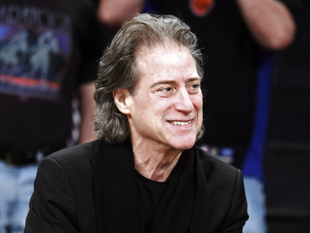 Comedian Richard Lewis attends an NBA basketball game in Los Angeles on Dec. 25, 2012. Lewis, an acclaimed comedian known for exploring his neuroses in frantic, stream-of-consciousness diatribes, has died at age 76.