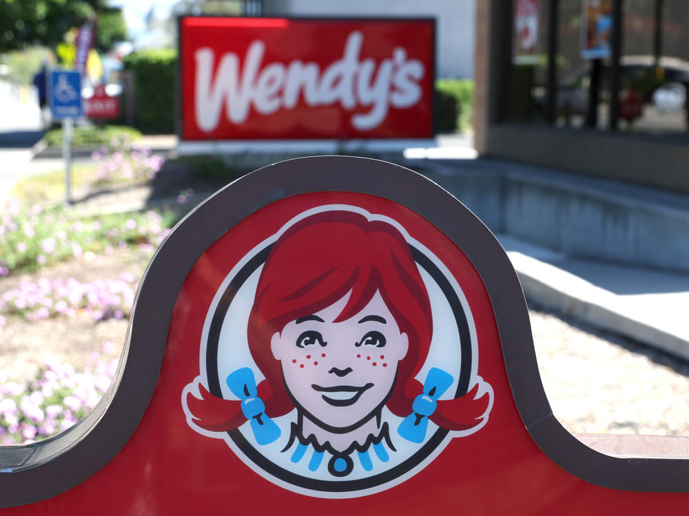 A sign is posted in front of a Wendy's restaurant on Aug. 10, 2022, in Petaluma, Calif. The company said Tuesday that it's planning to experiment with dynamic pricing.