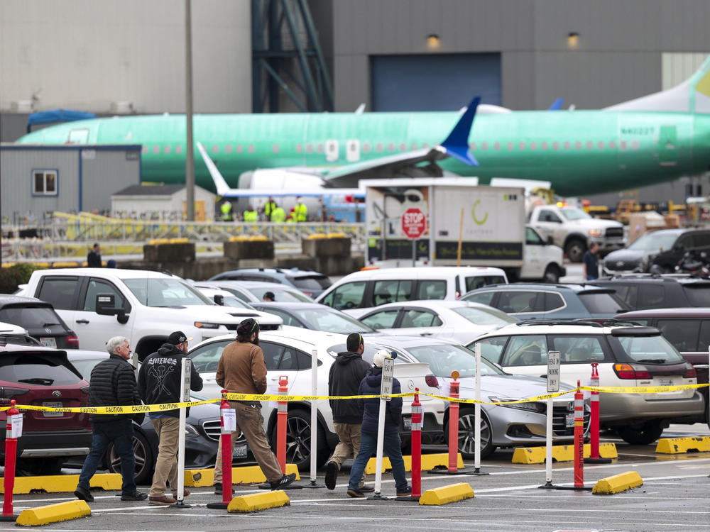 Workers and an unpainted Boeing 737 Max aircraft are pictured as the company's factory teams held a 