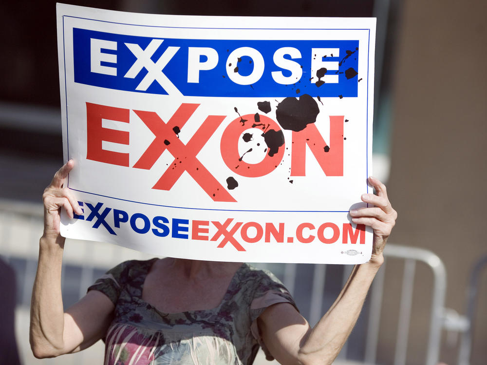 A protester holds a sign outside of the ExxonMobil annual shareholders meeting in Dallas in 2008.