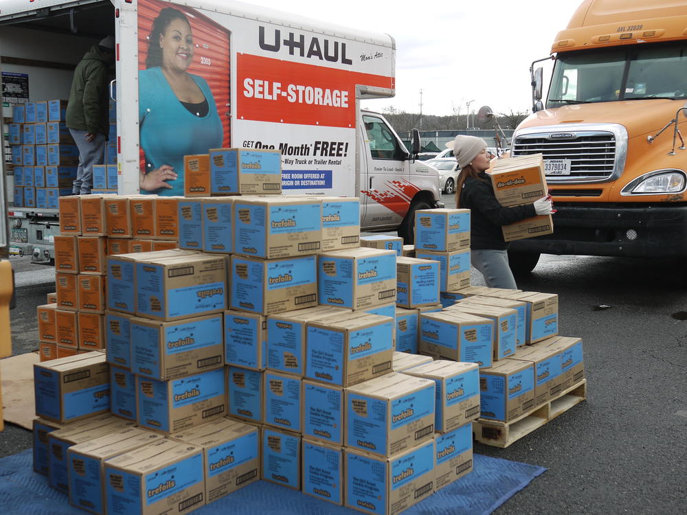 Volunteers load Trefoils and other Girl Scout Cookies at a huge parking lot near the RFK Stadium in Washington, D.C.