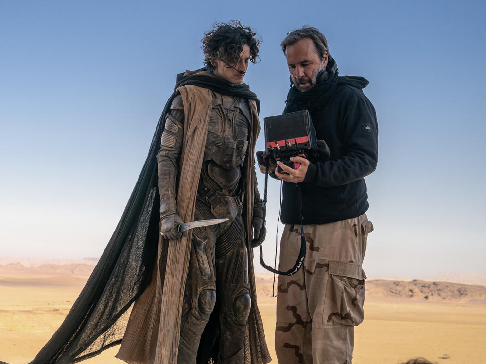 Timothée Chalamet and Denis Villeneuve confer on the set of <em>Dune: Part Two.</em>
