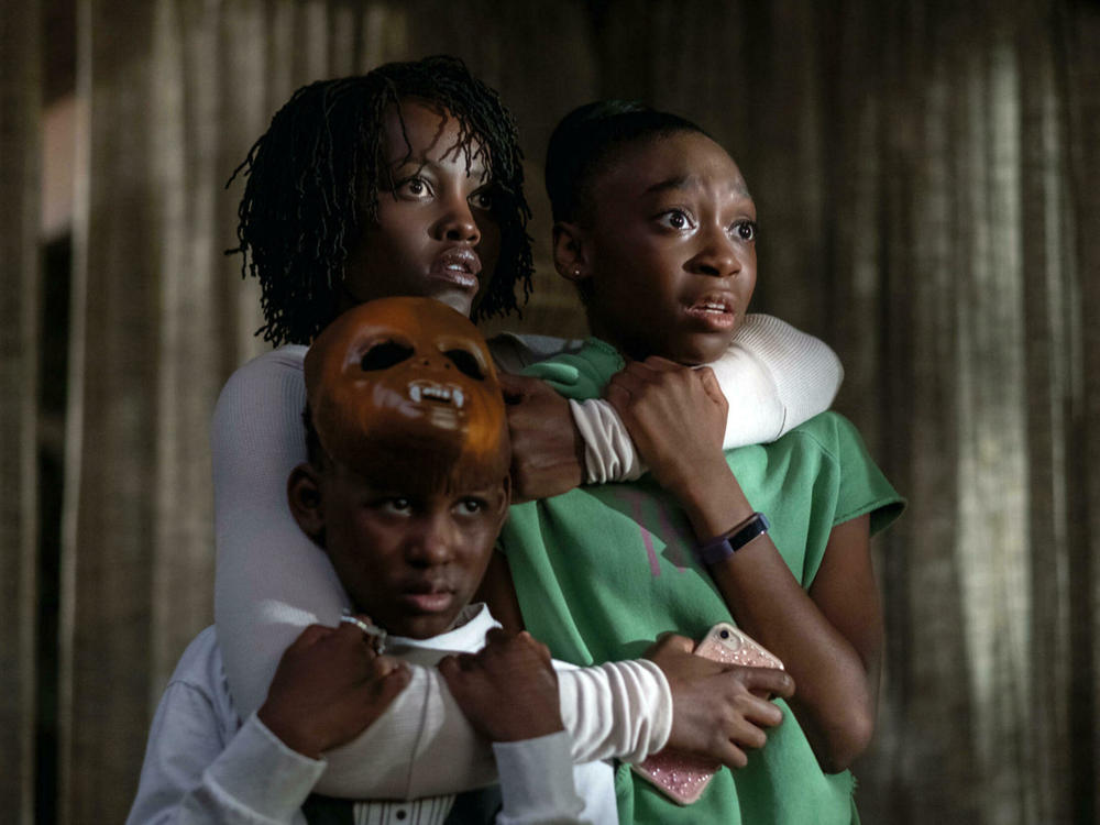 Lupita Nyong'o hugs her children, played by Evan Alex and Shahadi Wright Joseph, in the 2019 film, <em>Us,</em> written and directed by Jordan Peele.