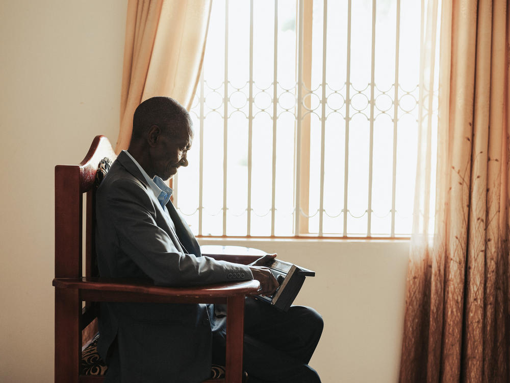 Makanga Kamulegeya likes to sit by his window with his radio and watch passersby. 