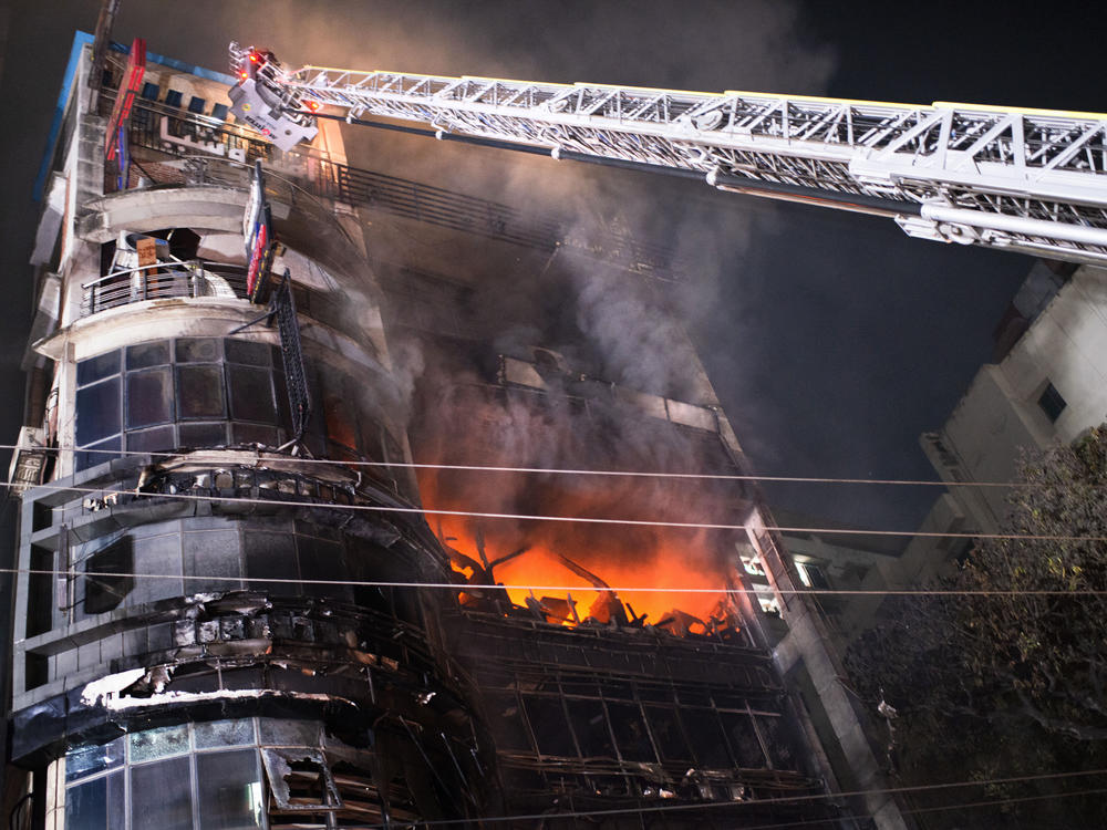 Firefighters work to contain a fire that broke out at a commercial complex in Dhaka, Bangladesh, on Thursday.