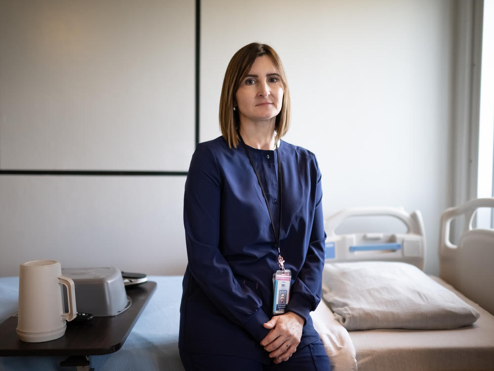 Kristin Grunewaldt, a registered nurse clinical coordinator at the Minnesota Correctional Facility in Oak Park Heights, sits on a bed in the prison's Transitional Care Unit. This unit is for elderly and sick prisoners who need 24-hour care.