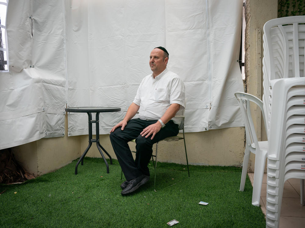 Chaim Otmazgin, 50, poses for a portrait in his home in Petah Tikva, Israel.