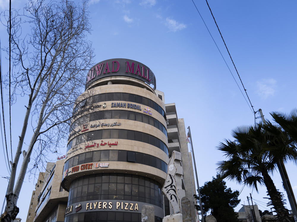 Silwad Mall is a shiny, block-long development capped with a stout cylindrical tower featuring a pizzeria, boutiques and a two-story travel agency that specializes in U.S. visas and travel.