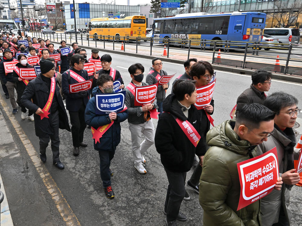 Doctors are shown marching toward the Presidential Office during a rally to protest against the government's plan to raise the annual enrolment quota at medical schools, in Seoul on Feb.25, 2024.