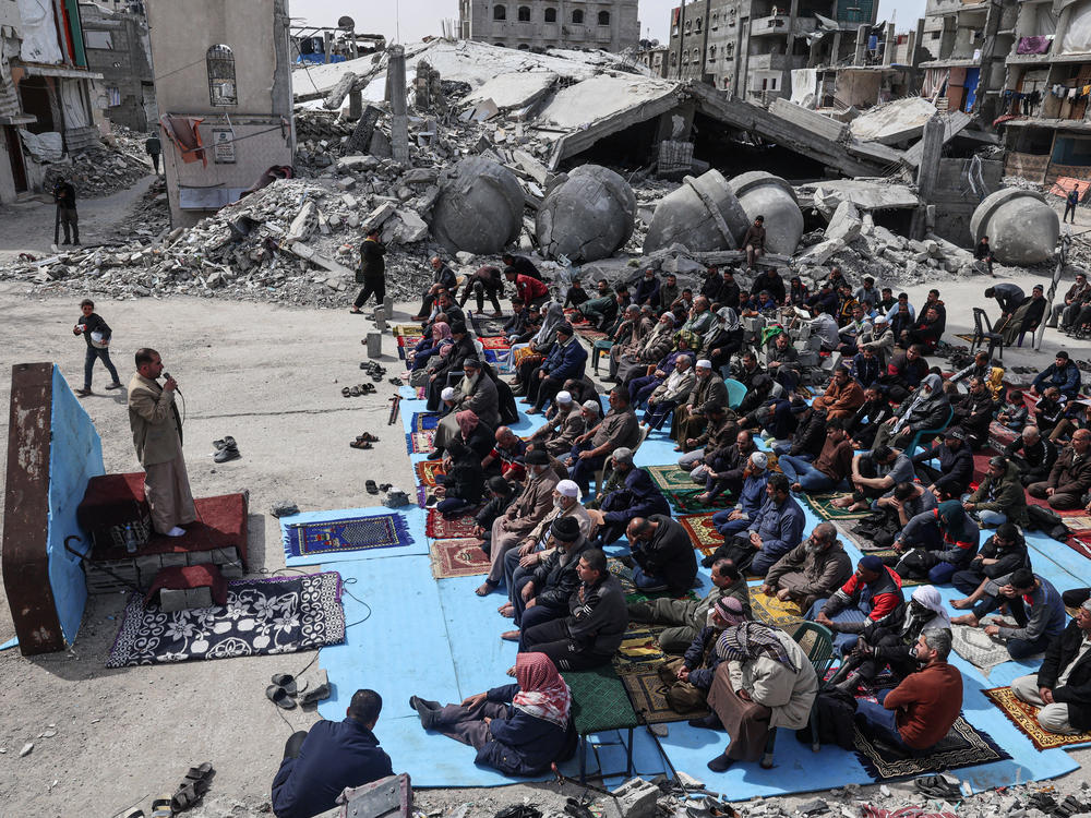 Palestinians attend Friday noon prayers on Friday, March 1, in front of the ruins of the al-Faruq mosque, which wass destroyed in Israeli strikes on Rafah, in southern Gaza.